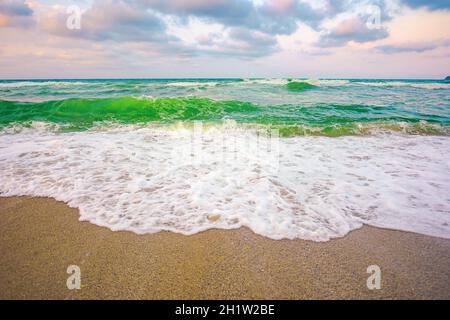 paesaggio serale al mare. splendido paesaggio naturale. concetto di vacanza estiva. cielo spettacolare sopra l'orizzonte. le onde scorrono sulla spiaggia di sabbia Foto Stock