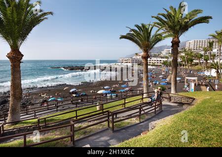 Playa de la Arena, Tenerife, Spagna - 17 febbraio 2019: Vista sulla spiaggia di sabbia nera con servizi sulla costa occidentale dell'isola. Foto Stock