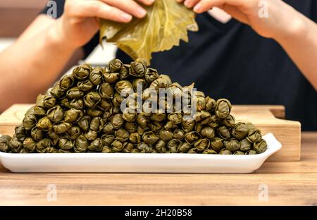 donna che prepara il sarma turco in cucina. Foto Stock