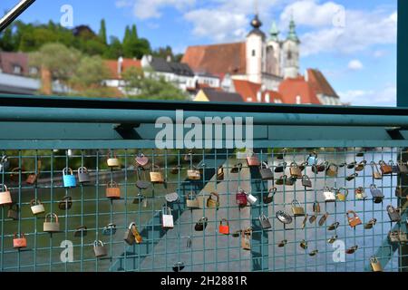 Liebesschlösser auf einem Steg in Steyr mit der Pfarrkirche Sankt Michael im Hintergrund, Österreich, Europa - l'amore si blocca su un ponte a Steyr con Th Foto Stock
