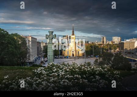 Piazza della libertà con la colonna della Vittoria della Guerra d'Indipendenza e la Chiesa di San Giovanni - Tallinn, Estonia Foto Stock