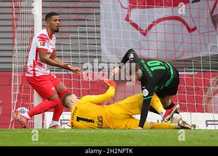 23 ottobre 2021, Sassonia, Lipsia: Calcio: Bundesliga, giorno 9: RB Leipzig - SpVgg Greuther Fürth alla Red Bull Arena. Peter Gulacsi (M), portiere di Lipsia, e Cedric Itten di Fürth in un duello, accanto a Benjamin Henrichs di Lipsia. L'obiettivo era vietato. Foto: Jan Woitas/dpa-Zentralbild/dpa - NOTA IMPORTANTE: In conformità con le norme del DFL Deutsche Fußball Liga e/o del DFB Deutscher Fußball-Bund, è vietato utilizzare o utilizzare fotografie scattate nello stadio e/o del match sotto forma di immagini sequenziali e/o di serie fotografiche video-simili. Foto Stock