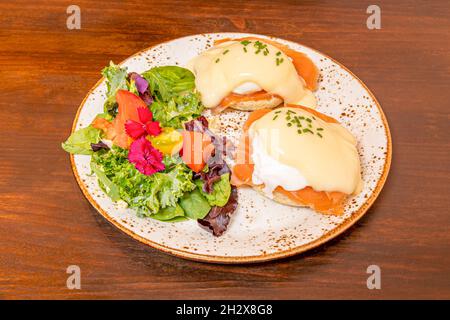 Uova Benedict piatto anglosassone composto da due metà di un muffin inglese, salmone norvegese affumicato, uova in camicia e la molto popolare Hollandaise s Foto Stock