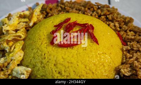Tradizionale cucina indonesiana 'Nasi Kuning' sul piatto Foto Stock