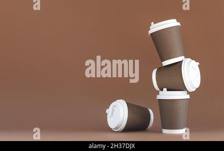 Pila di tazze di carta marrone usa e getta con tappi Foto Stock