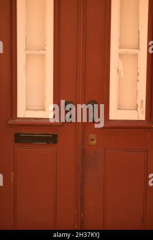 Porta rossa con maniglie ornate in Portogallo Foto Stock