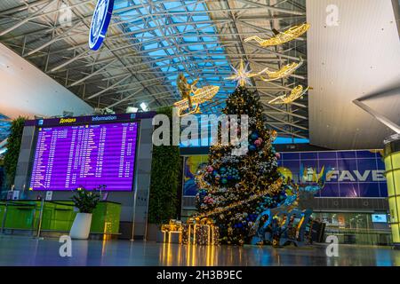 Ucraina, Kiev - 29 dicembre 2020: Banco check-in vuoto per un volo per l'aeroporto. Natale. Decorazioni per l'anno nuovo all'aeroporto di Boryspil. Ghirlande e luci, inverno in vacanza. Foto Stock