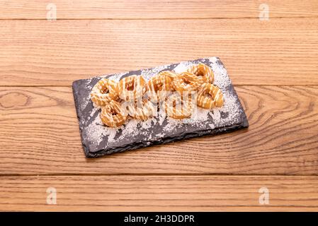 Zucchero churros con panna, cioccolato bianco e zucchero a velo Foto Stock