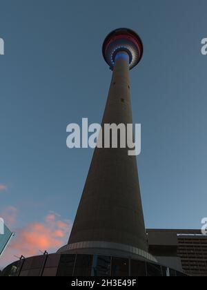 Vista ad angolo basso del famoso punto di riferimento della Calgary Tower nel centro cittadino con piattaforma di osservazione illuminata alla luce della sera. Foto Stock