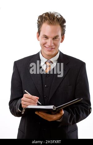 Uomo d'affari che scrive al taccuino Foto Stock