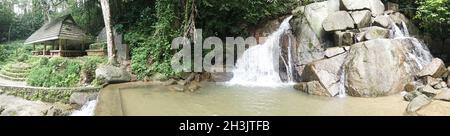 Piccola cascata di montagna sulle rocce e accogliente alcove foe rilassarsi nella foresta tropicale Foto Stock