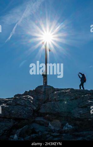 Bayerisch Eisenstein, Germania. 29 ottobre 2021. Gli escursionisti scattano foto alla croce sulla cima del Großer Arber, alto 1456 metri, nella foresta bavarese. Credit: Armin Weigel/dpa/Alamy Live News Foto Stock