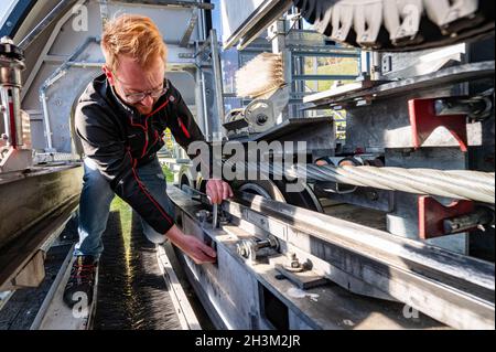 Bayerisch Eisenstein, Germania. 29 ottobre 2021. Jonas Wallner, tecnico della funivia, lavora in un impianto di risalita. Poiché in Germania il tecnico della strada non è una descrizione del lavoro riconosciuta, il tecnico ha completato la sua formazione in Austria presso la Landesberufsschule Hallein, in provincia di Salisburgo. (To dpa: ''We like to tinker' - tecnici di costruzione impianti di risalita per impianti di risalita') Credit: Armin Weigel/dpa/Alamy Live News Foto Stock