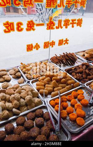 Vassoi di snack misti e snack, eventualmente snack salati, in vendita in un negozio nella cinta muraria antica città cinese (antica città fortificata) di Songpan nel nord del Sichuan, Cina. (125) Foto Stock