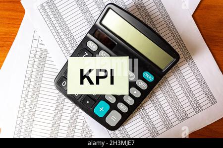 KPI Abbreviazione Key Performance Indicator Desktop con rendiconto finanziario e calcolatrice Foto Stock