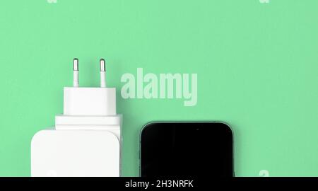 Adattatore caricabatterie USB, caricabatterie mobile per smartphone. Tipo UE. Sfondo Mint, disposizione piatta, vista dall'alto e spazio di copia Foto Stock