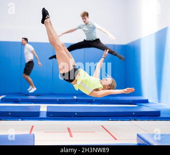 Ginnastica femminile che salta sul trampolino Foto Stock