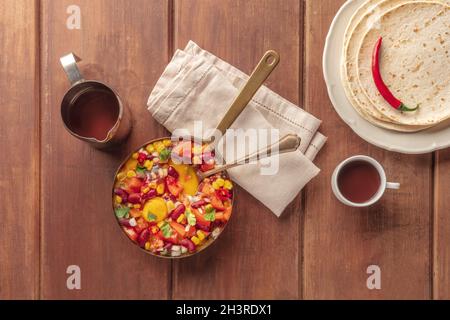 Huevos rancheros, uova messicane al forno, sparate dall'alto con insalata Pico de gallo Foto Stock