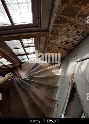 Old wooden stairs and rustic windows from a old building Stock Photo