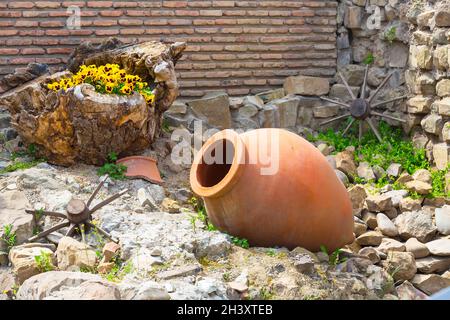 Vecchia regione vinicola georgiana tradizionale simbolo sfondo con ruota e qvevri caraffa Foto Stock