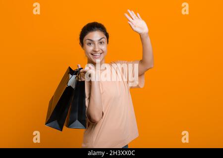 La donna indiana tiene i sacchetti di shopping nelle mani. Vendita e Black Friday. Foto Stock