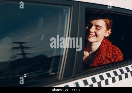 La giovane donna si siede in taxi car sul sedile posteriore Foto Stock