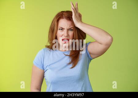 Och mi calci la testa. Frustrato interessato sconvolto medio-vecchio sguardo della donna redhead scioccato angosciato touch tempio lamentarsi capretto sh Foto Stock