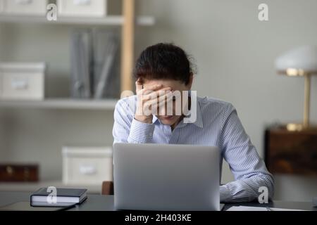 Infelice donna d'affari di mezza età che soffre di mal di testa. Foto Stock