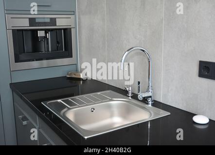 Moderno lavello da cucina, rubinetto d'acqua e rubinetto cromato per lavabo da cucina Foto Stock