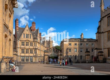 Gli studenti camminano su New College Lane, passando sotto il Ponte dei Sospiri. L'edificio del New College si trova sulla sinistra. Oxford, Regno Unito Foto Stock