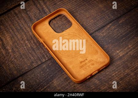 Antalya, Turchia - 28 ottobre 2021: Custodia in pelle Golden Brown MagSafe di nuova progettazione per Apple iPhone 13 Pro su sfondo in legno Foto Stock