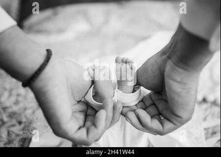 il bambino piccolo piede il bambino sul braccio del padre Foto Stock