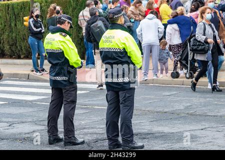 Huelva, Spagna - 30 ottobre 2021: Vista posteriore della polizia spagnola con l'emblema del logo 'polizia locale' su uniforme mantenere l'ordine pubblico nelle strade di Hue Foto Stock