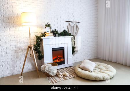 Camino moderno e lampada luminosa in camera decorata per Natale Foto Stock
