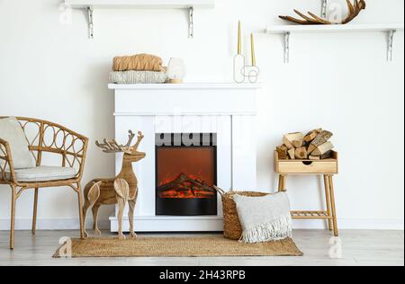 Camino elettrico in sala luminosa decorato per Natale Foto Stock