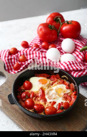 Padella con il gustoso Shakshouka sul tavolo Foto Stock