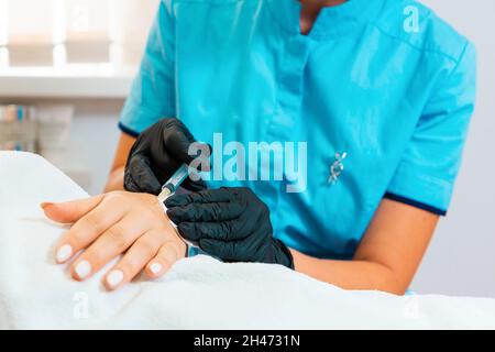 Procedura in salone di bellezza. Il medico effettua iniezioni di tossina botulinica sulla mano del cliente contro l'iperidrosi. Primo piano. Concetto di cura della pelle. Foto Stock