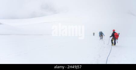 Gruppo di alpinisti del ghiacciaio su una corda Foto Stock