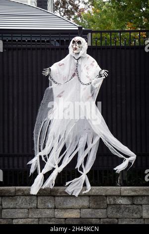 DECORAZIONI DI HALLOWEEN. Un fantasma a grandezza naturale che si muove nel vento come parte di elaborate decorazioni al di fuori di una casa a Flushing, Queens, New York City. Foto Stock