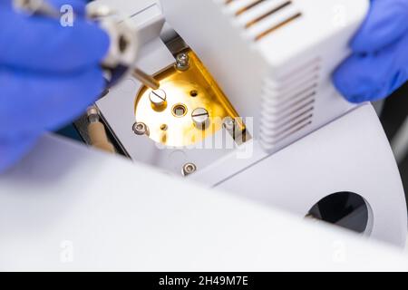 Il chimico inzera un nebulizzatore nella sorgente ionica dello spettrometro di massa. Cromatografia liquida con rilevatore di massa. Manutenzione dello strumento. Foto Stock