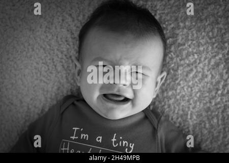 Bambino di due mesi urla e piange, immagine in bianco e nero Foto Stock