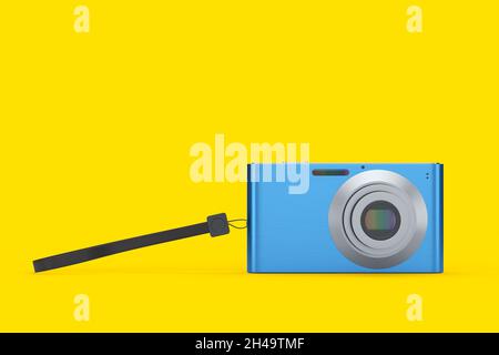 Elegante fotocamera digitale tascabile compatta blu isolata su sfondo giallo. Concetto di destinazione di viaggio in vacanza con rendering 3D Foto Stock