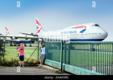 I turisti fotografano una fila di British Airways 747 all'aeroporto di Cotswold a Kemble Gloucestershire che si ritiene siano in attesa di una compagnia di salvataggio aereo per r Foto Stock