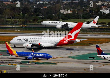 Los Angeles, California, Stati Uniti. 28 marzo 2019. Un Qantas Airbus se A380-800 (registrazione VH-OQA) decollo come Japan Air Lines (JAL) Boeing 777-300ER (registrazione JA742J) atterra e un Boeing Co. Southwest Airlines 737 taxi all'aeroporto internazionale di Los Angeles (LAX) giovedì 28 marzo 2019 a Los Angeles, California © 2019 Patrick T. Fallon. (Credit Image: © Patrick Fallon/ZUMA Press Wire) Foto Stock