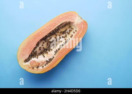 fetta di papaia su sfondo blu con spazio copia Foto Stock