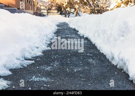 Strada invernale con sale per sciogliere la neve Foto Stock