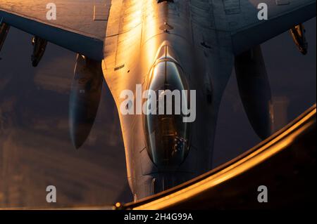 Un pilota della US Air Force F-16 Fighting Falcon attende di ricevere carburante da una US Air Force KC-135R Stratotanker al di sopra della US Central Command Area of Responsibility, 25 ottobre 2021. Il KC-135 fornisce a U.S. Air Forces Central una capacità di rifornimento aereo globale per supportare gli aerei della nazione congiunta e partner in tutta l'area di responsabilità del comando centrale degli Stati Uniti. (STATI UNITI Air Force foto di Senior Airman Frank Rohrig) Foto Stock