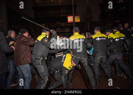 L'Aia, Paesi Bassi. 2 novembre 2021. La polizia si scontra con i manifestanti durante la manifestazione. La polizia ha arrestato tredici persone durante una manifestazione anti-corona, come nuove misure del Covid 19 sono state annunciate dal primo ministro olandese uscente, Mark Rutte. Qualche centinaio di persone si sono riunite fuori dal “Ministero della Giustizia e della sicurezza” sul Turfmarkt, con il suono assordante di fischi, grida, musica, il banging di pentole e tamburi da cucina, e le occasionali fuochi d’incendio e razzi rossi. Credit: SOPA Images Limited/Alamy Live News Foto Stock