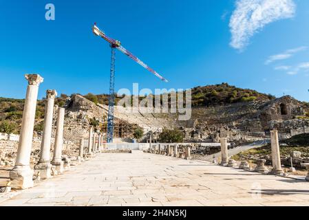 Efeso, Turchia – 2 novembre 2020. Harbour Street conduce al Grande Teatro presso l'antico sito di Efeso in Turchia. Vista con una gru da cantiere. Foto Stock