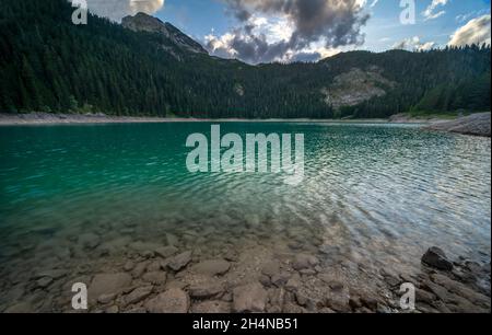 Spettacolari cieli colorati e la luce in una famosa area escursionistica, con il Monte Durmitor con paesaggi glaciali e terreno, a fine estate, in alto nel Foto Stock